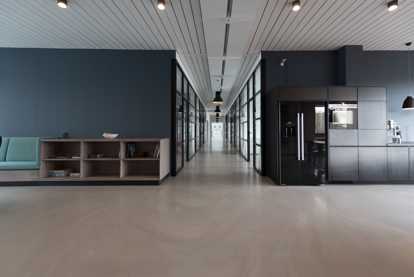 Bright modern European office with glass walls and collaborative workspaces